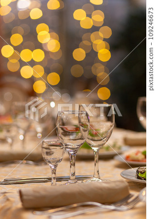 Served festive table with snacks, glasses, glasses, cutlery and napkins for a banquet Served festive table with snacks, glasses, glasses, cutlery and napkins for a banquet 109246673