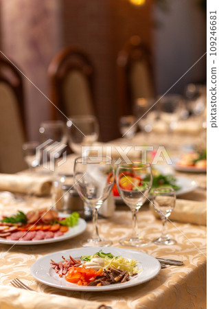 Served festive table with snacks, glasses, glasses, cutlery and napkins for a banquet Served festive table with snacks, glasses, glasses, cutlery and napkins for a banquet 109246681