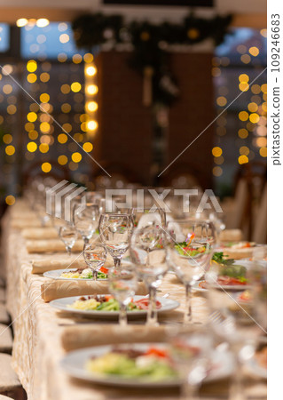 Served festive table with snacks, glasses, glasses, cutlery and napkins for a banquet Served festive table with snacks, glasses, glasses, cutlery and napkins for a banquet 109246683