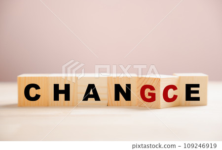 CHANGE to CHANCE - wooden cube transformation. Hand flips block, representing personal development and growth. Business concept of seizing opportunities. Innovative leadership on a wood background. 109246919