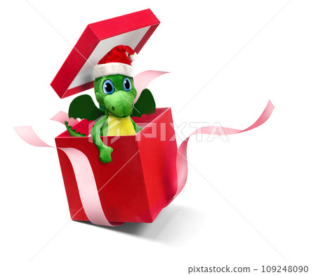 Adorable little green dragon in a Santa hat in red gift box isolated on white Adorable little green dragon in a Santa hat in red gift box isolated on white 109248090
