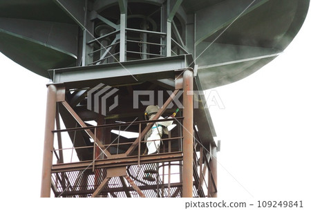 Sand blasting process. Industrial worker in protective uniform cleaning surface of big steel construction before painting on high altitude. Sand blasting process. Industrial worker in protective uniform cleaning surface of big steel construction before painting on high altitude. 109249841