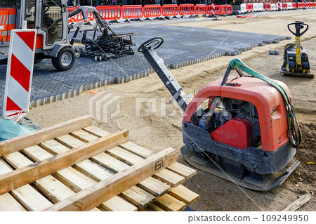 Repaved place, mobile plate compactors, block laying machine, warning signs, plastic barriers Repaved place, mobile plate compactors, block laying machine, warning signs, plastic barriers 109249950