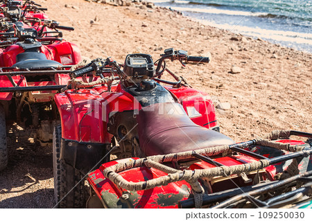 Red quads stand in a row on the shore of the Red Sea. Dahab, Egypt. Red quads stand in a row on the shore of the Red Sea. Dahab, Egypt. 109250030