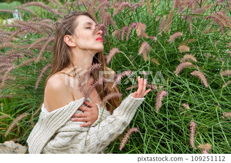 Beautiful caucasian woman near bush. 109251112