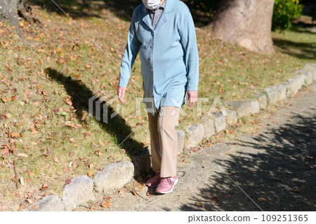 Senior woman walking slowly for health. Elderly people who feel unsteady. Diet, exercise, healthy habits, walking. Senior woman walking slowly for health. Elderly people who feel unsteady. Diet, exercise, healthy habits, walking. 109251365