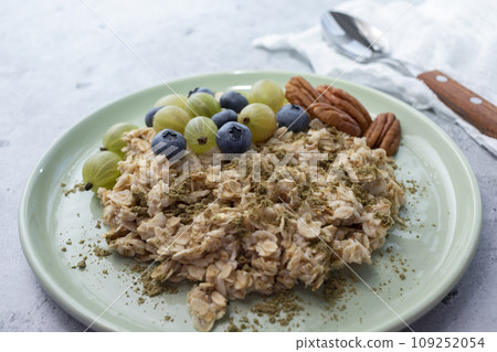 Closeup Oatmeal Porridge With Hemp Protein Powder, Berries, Nut On Plate. Body hacking, Biohacking Healthy Breakfast With Plant derived Protein from Cannabis Plant. Superfood, Healthy Meal Horizontal 109252054