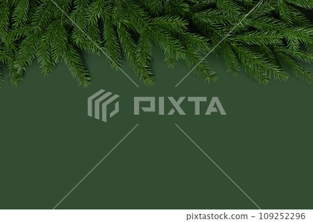 Christmas border with fir branches. Christmas green background with a copy space. New Year card. Top view, flat lay. 109252296