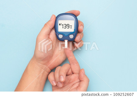 Man using glucometer, blood glucose test 109252607