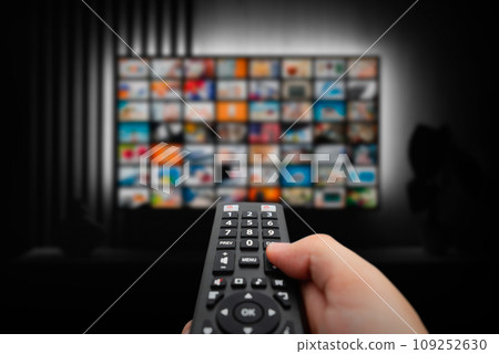 Man watching TV with remote control in hand. Man watching TV with remote control in hand. 109252630