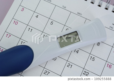Positive pregnancy test on calendar. Positive pregnancy test on calendar. 109255888
