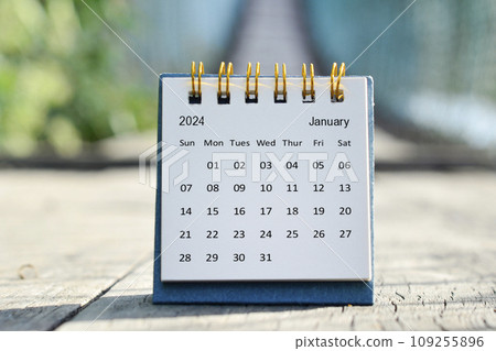 January 2024 white calendar with green blurred background. New year concept. 109255896