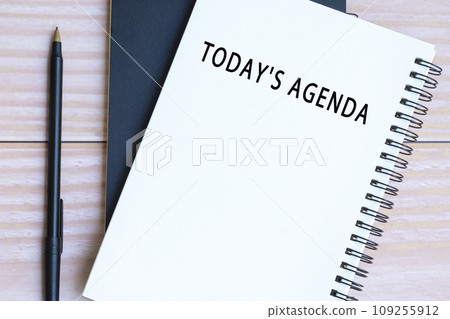 Today's agenda text on notepad with pen on wooden desk. 109255912