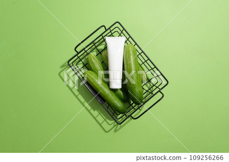 View from above of a black basket containing several cucumbers and a blank label tube placed on top. Cucumbers contain both vitamin C and folic acid View from above of a black basket containing several cucumbers and a blank label tube placed on top. Cucumbers contain both vitamin C and folic acid 109256266