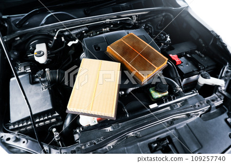 Comparison of car air filters , new filters and clogged filters on cover engine 109257740