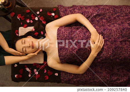 Woman receiving a massage from an esthetician Woman receiving a massage from an esthetician 109257840
