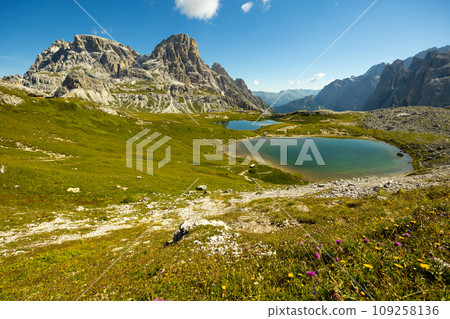 View of rocky summits of Sexten Dolomites and mountain lakes Laghi dei Piani View of rocky summits of Sexten Dolomites and mountain lakes Laghi dei Piani 109258136
