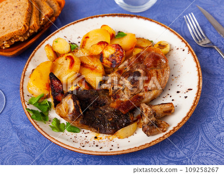 Roasted leg of lamb served with potatoes Roasted leg of lamb served with potatoes 109258267
