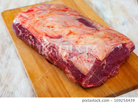 Raw beef tenderloin on wooden cutting board Raw beef tenderloin on wooden cutting board 109258439
