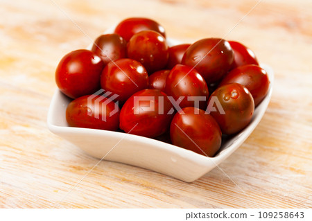 Fresh cherry tomatoes ready for cooking on table 109258643