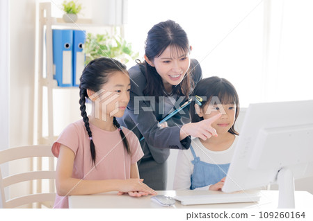 Girl taking lessons using a computer Girl taking lessons using a computer 109260164