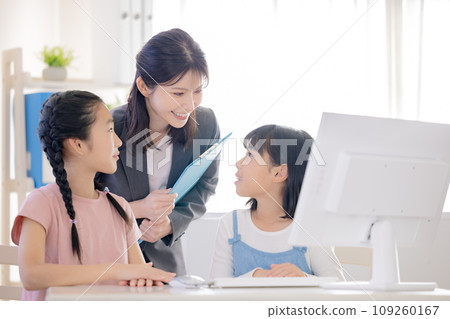 Girl taking lessons using a computer Girl taking lessons using a computer 109260167