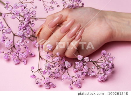 Female hands with beautiful manicure on pink background Female hands with beautiful manicure on pink background 109261248