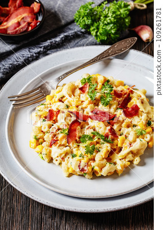 mac and cheese with corn, bacon topped with panko breadcrumbs on plates with fork mac and cheese with corn, bacon topped with panko breadcrumbs on plates with fork 109261781