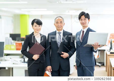Middle-aged male and female businessmen in management positions working in the office Middle-aged male and female businessmen in management positions working in the office 109262360