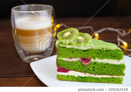 Pistachio cake with kiwi, cream and raspberry filling and Cappuccino coffee Pistachio cake with kiwi, cream and raspberry filling and Cappuccino coffee 109262429