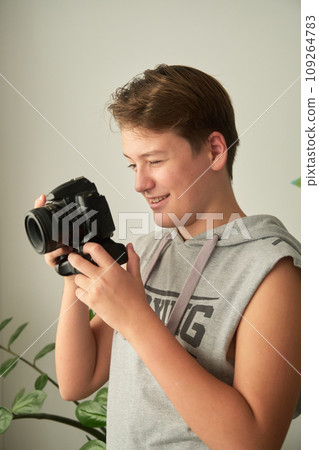 a boy with camera in his hands a boy with camera in his hands 109264783