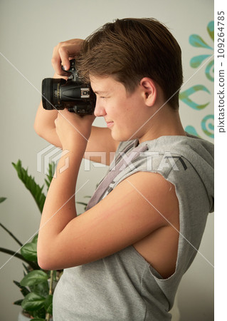 a boy with camera in his hands a boy with camera in his hands 109264785