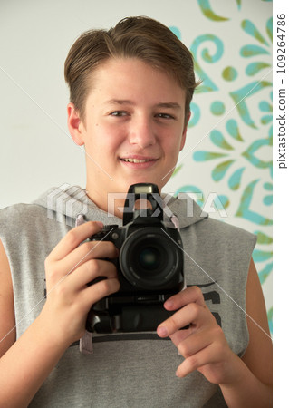 a boy with camera in his hands a boy with camera in his hands 109264786