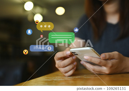Young woman using social media, commenting and sharing posts commenting on mobile phone Young woman using social media, commenting and sharing posts commenting on mobile phone 109265131