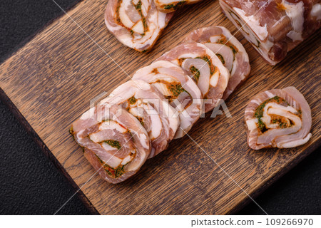 Delicious meatloaf with lard, salt, spices and herbs cut into slices Delicious meatloaf with lard, salt, spices and herbs cut into slices 109266970