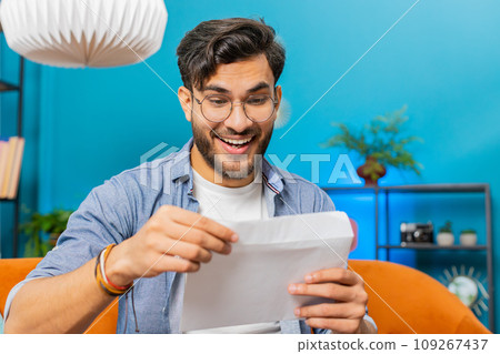 Man open envelope letter reads it feel happy, career growth advance promotion, bank loan approve 109267437