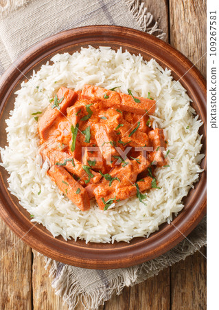 Korvstroganoff Swedish Sausage Stroganoff with rice closeup on the plate. Vertical top view 109267581