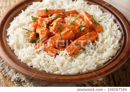 Korvstroganoff is the Swedish version of a dish known as beef Stroganoff prepared with a Swedish sausage falukorv with a side dish of rice closeup on the plate. Horizontal 109267584