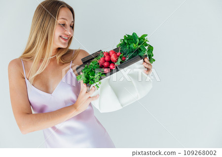 woman holding clutch with vegetables for eating woman holding clutch with vegetables for eating 109268002