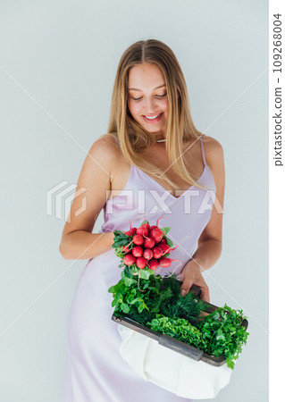 woman holding clutch with vegetables for eating woman holding clutch with vegetables for eating 109268004