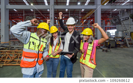 Celebrating Success. Hardhat construction worker raising their hand high, marking a victorious moment. 109268612