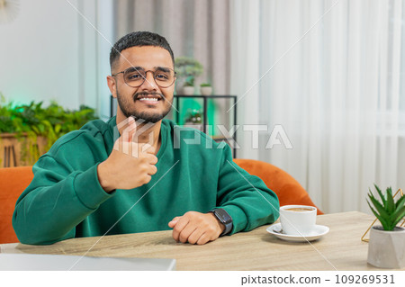 Happy Indian young man looking approvingly at camera show thumbs up like positive sign good news 109269531
