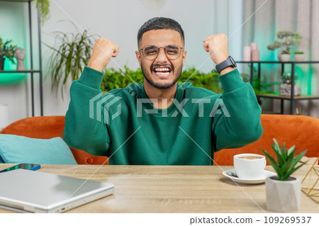 Excited happy Indian man surprised, shocked by sudden victory good win news celebrate wow reaction 109269537