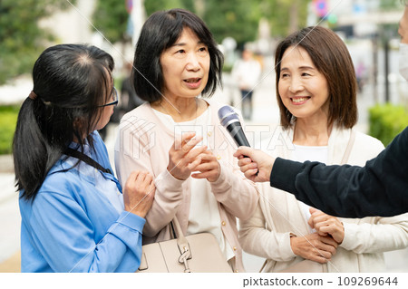 A woman responding to an interview on the street A woman responding to an interview on the street 109269644