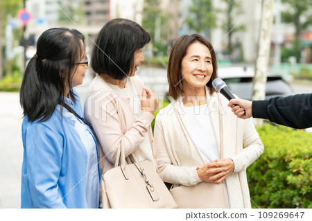 A woman responding to an interview on the street 109269647