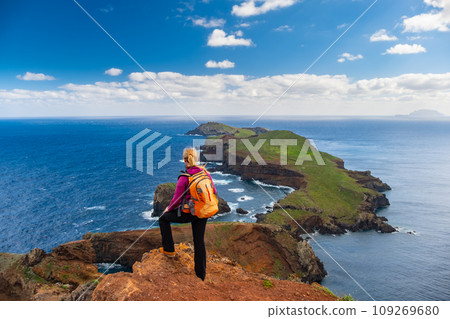 Tourists on hiking path on Ponta de Sao Lourenco Madeira Portugal. Green landscape cliffs and Atlantic Ocean. Ative day, travel background 109269680