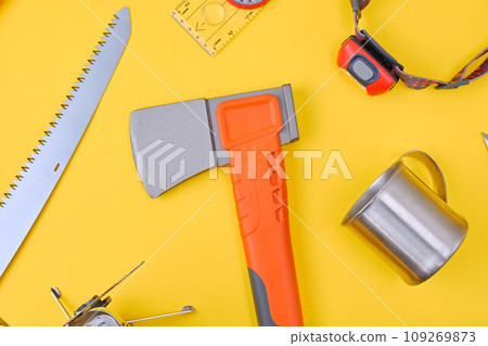 Camping and trekking equipment over yellow background Camping and trekking equipment over yellow background 109269873