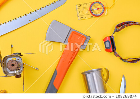 Camping and trekking equipment over yellow background Camping and trekking equipment over yellow background 109269874