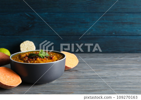 Sweet potato puree in bowl and vegetables on wooden background, space for text Sweet potato puree in bowl and vegetables on wooden background, space for text 109270163