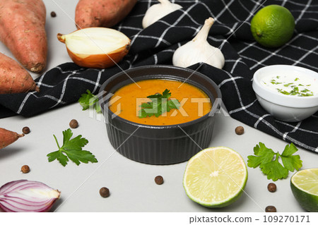 Sweet potato puree in bowl, towel and ingredients on white background 109270171